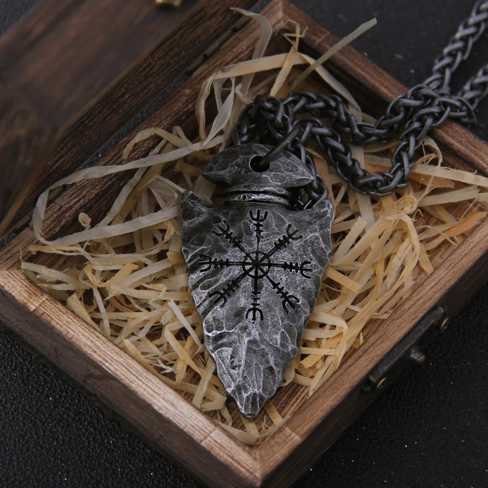 Celtic warrior necklace featuring a silver arrowhead pendant in a wooden jewelry box with straw
