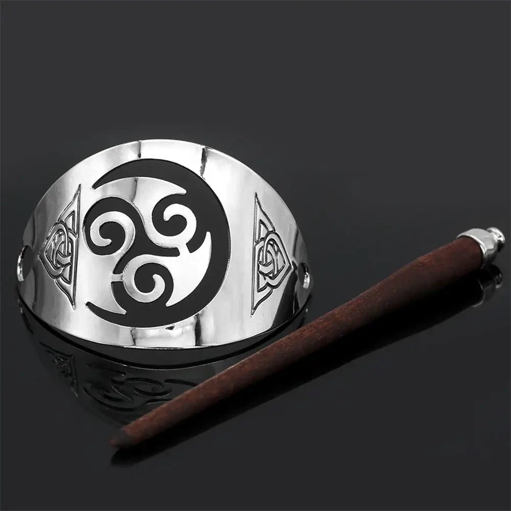 Celtic hairpin in metal with triskel design and wooden stick for elegant hairstyles.