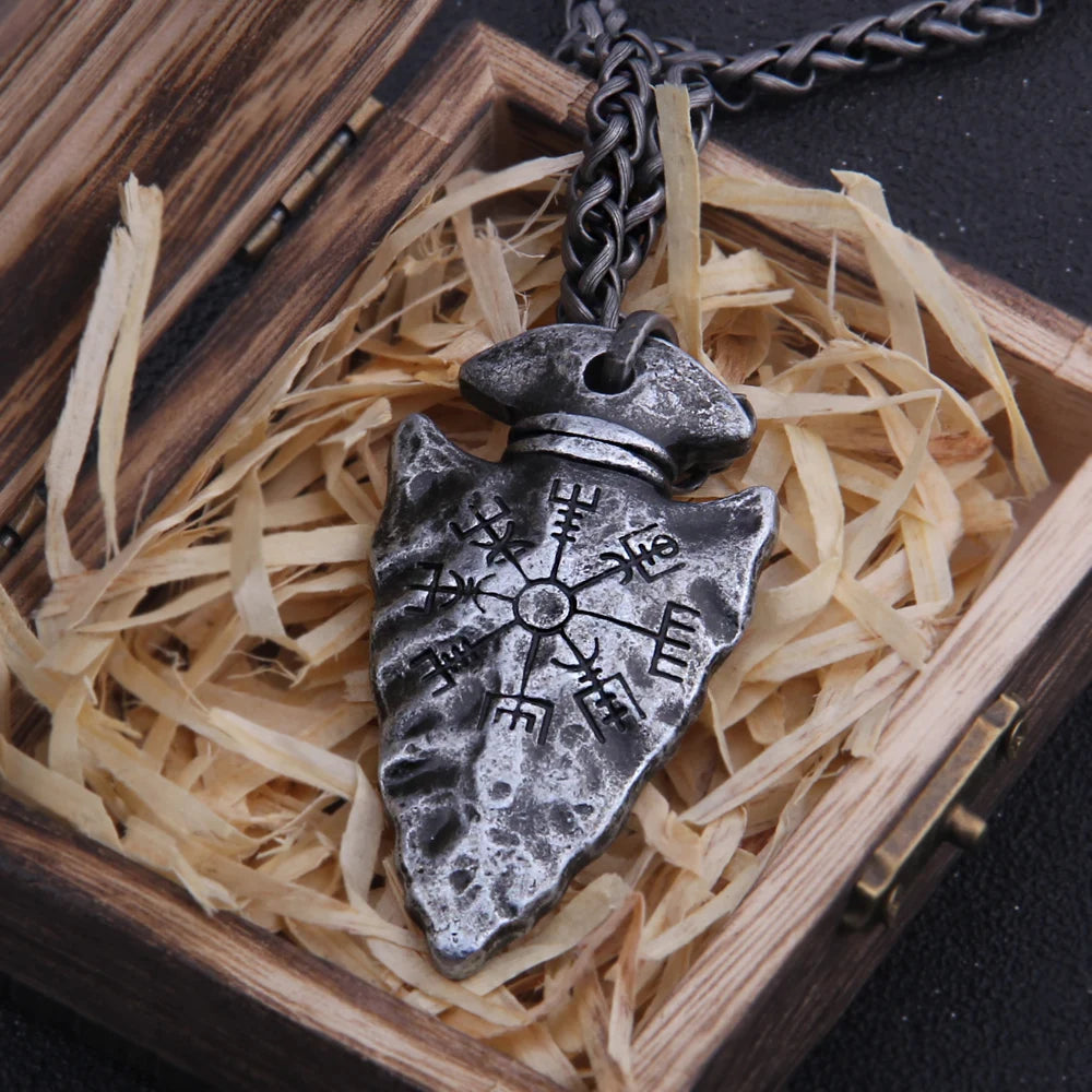 Celtic warrior arrowhead pendant in a wooden box with straw, showcasing intricate runic designs.