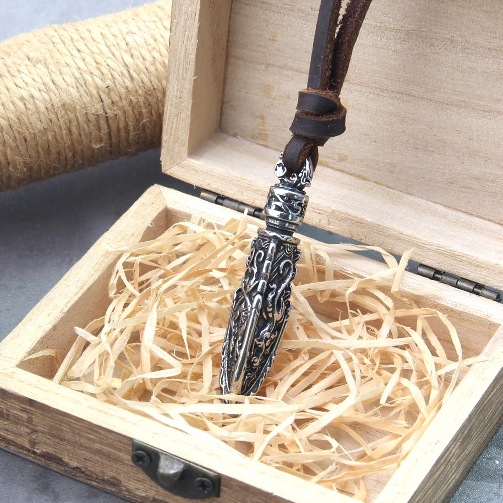 Celtic warrior arrow pendant in wooden box with straw, featuring intricate silver design and leather cord.