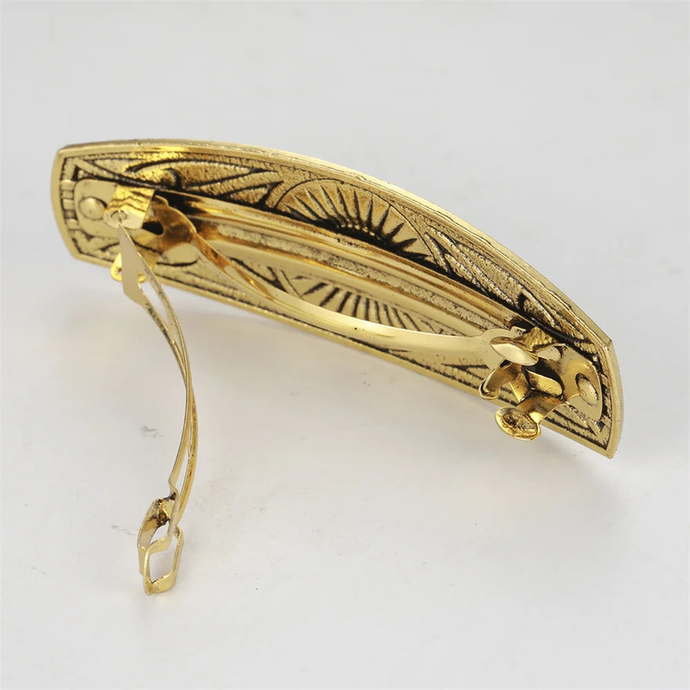 Gold Celtic barette, detailed design with clasp, perfect hair accessory for elegant styles.