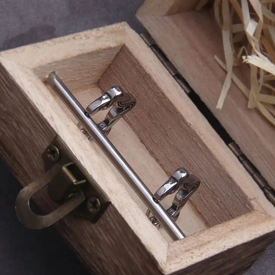 Inside view of a wooden box with a silver metal latch and decorative straw, showcasing a storage solution.