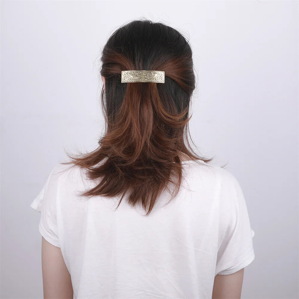 Elegant Celtic hair clip showcasing intricate design, worn in dark hair from a rear view.